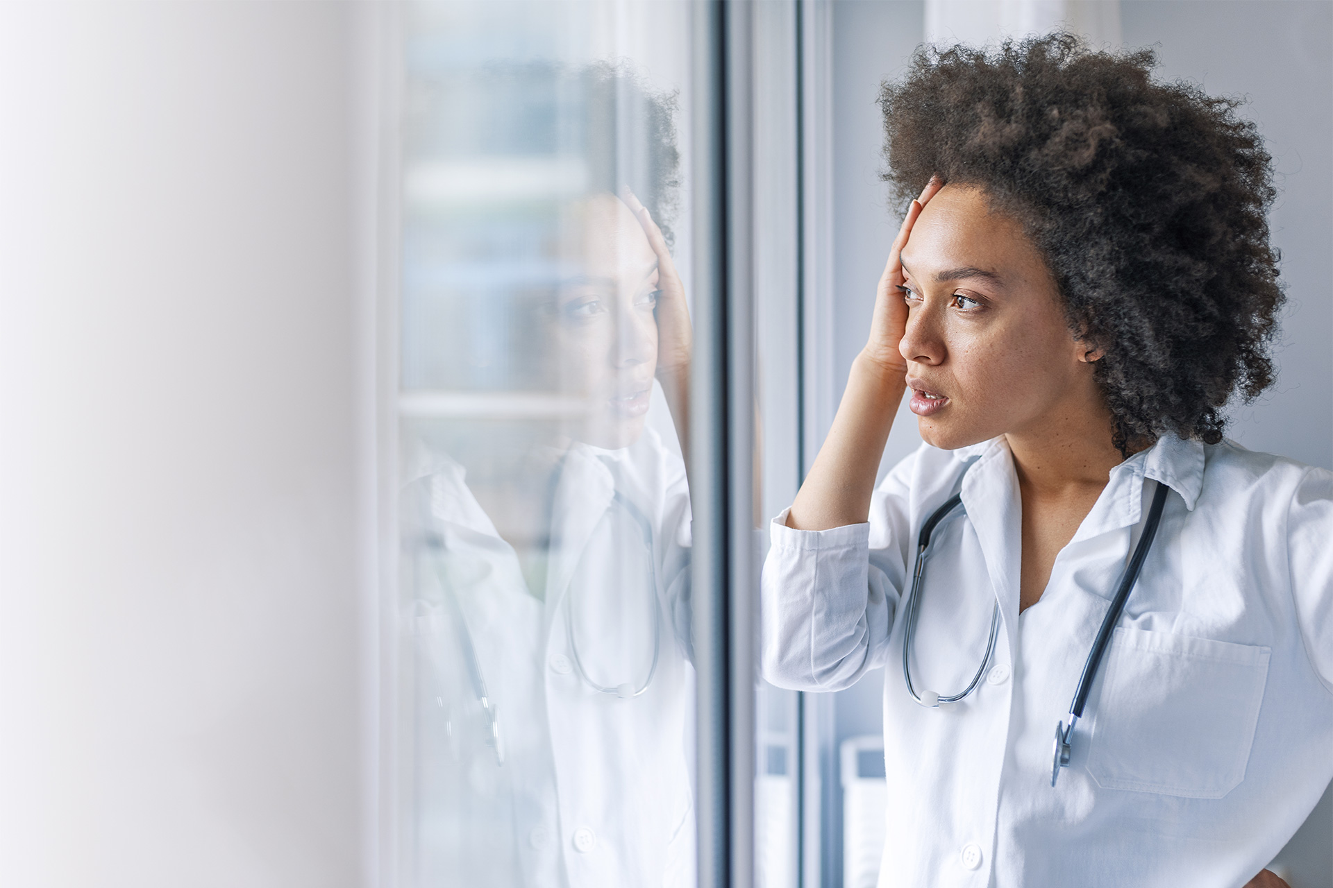 Female doctor looking out a window