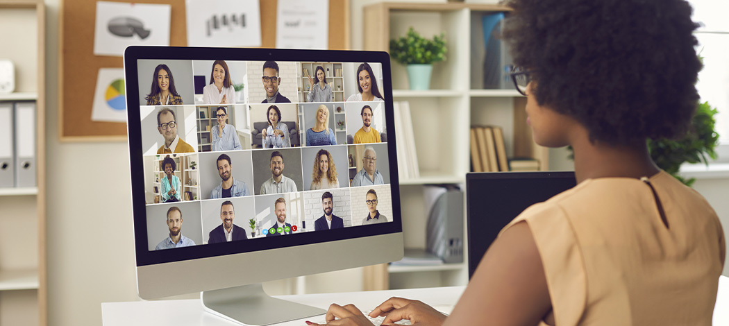 Women attend a virtual meeting.