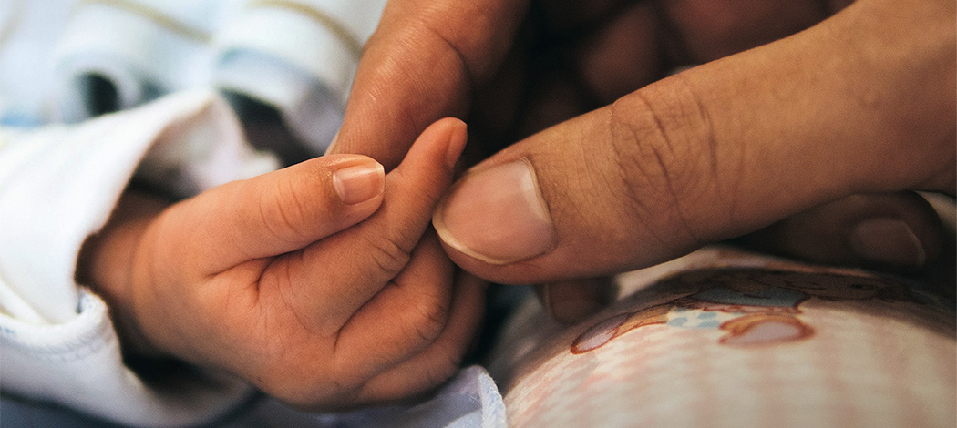 Woman holding baby's hand