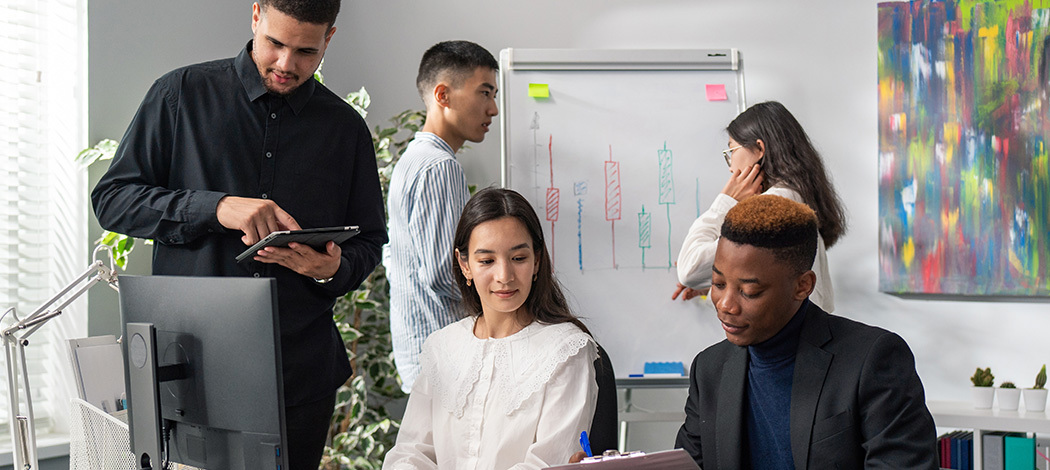 Diverse office workers working on project together dealing with pressure