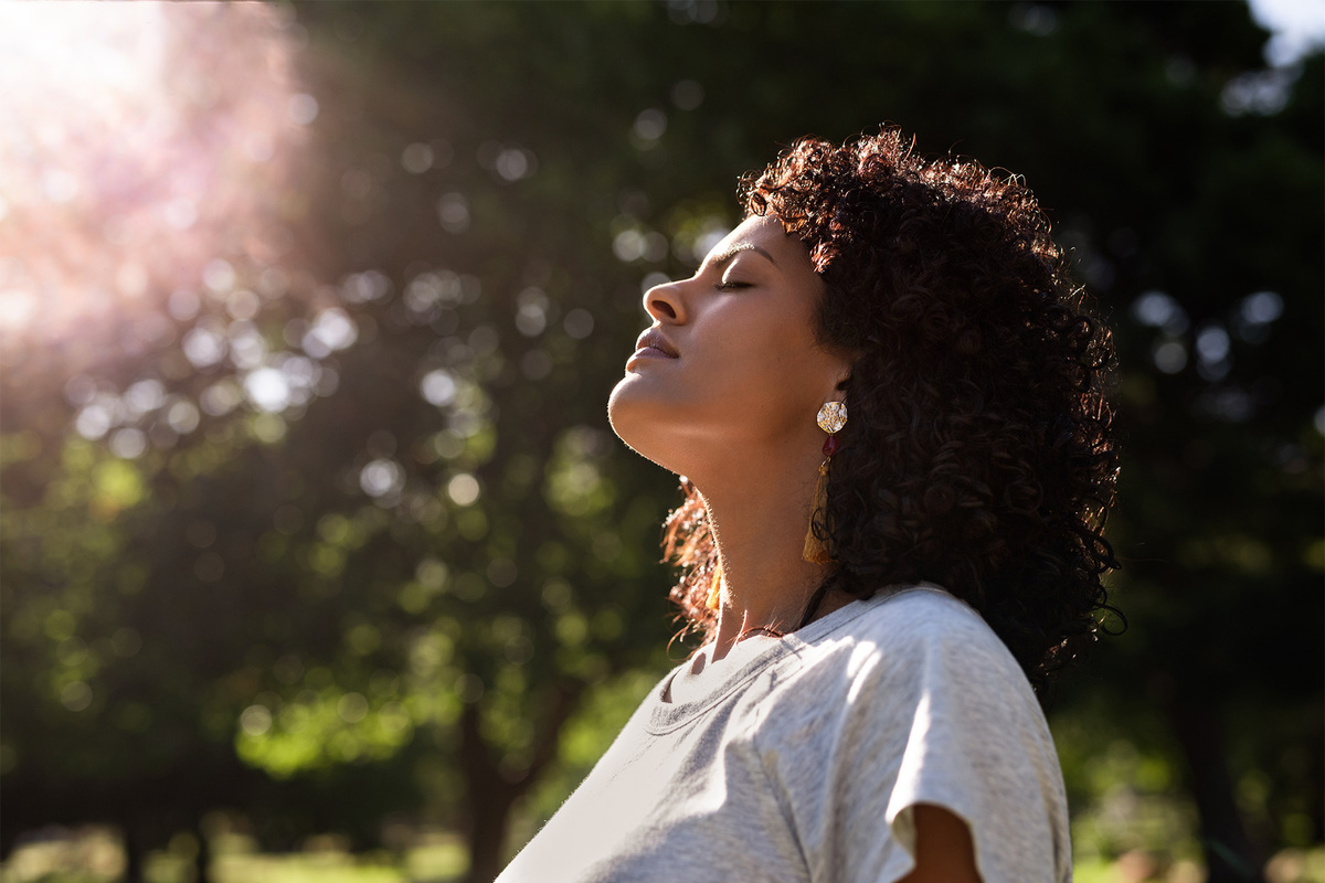 woman with eyes closed being mindful