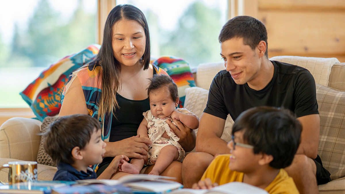 A Canadian Indigenous Family sitting in their living room at home