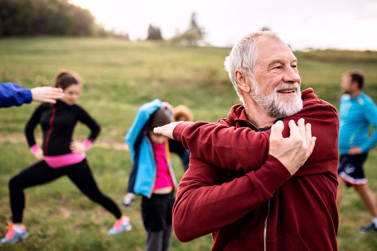 A nurtures his mind and body by exercising with a group outside.