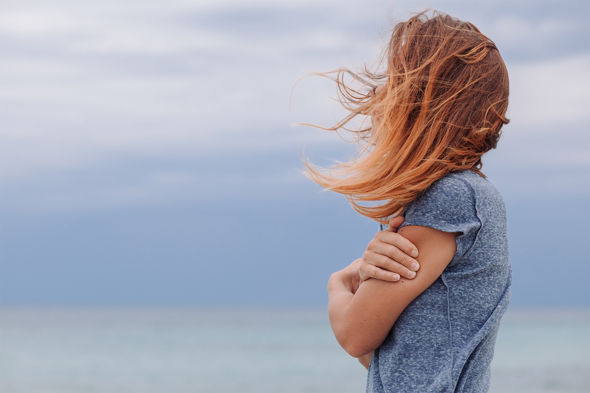 a woman stands while looking into the distance