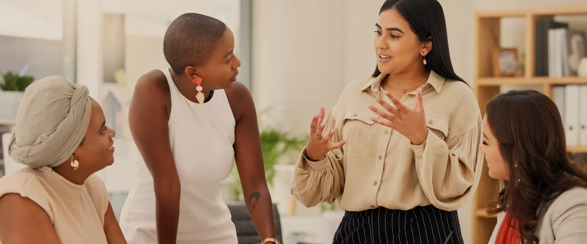Diverse women in a collaborative meeting at modern office space.