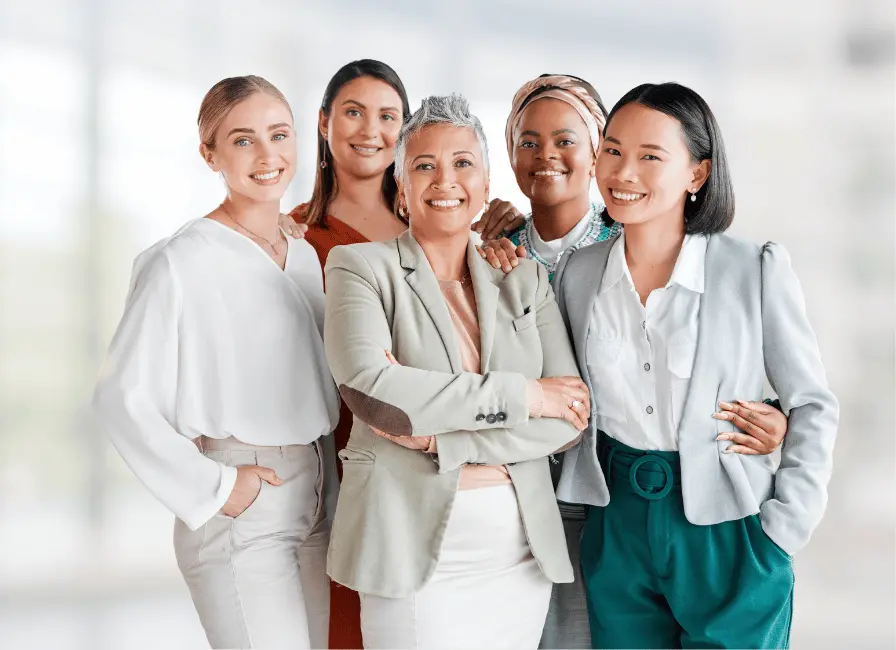 Diverse group of professional women smiling together, representing support for women’s health in the workplace