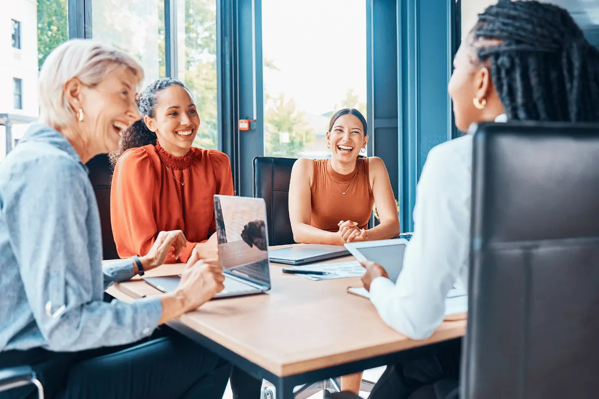 Employees discussing workplace wellness programs; LifeSpeak HR Director Amanda Martell featured on personalized wellness strategies for employee performance