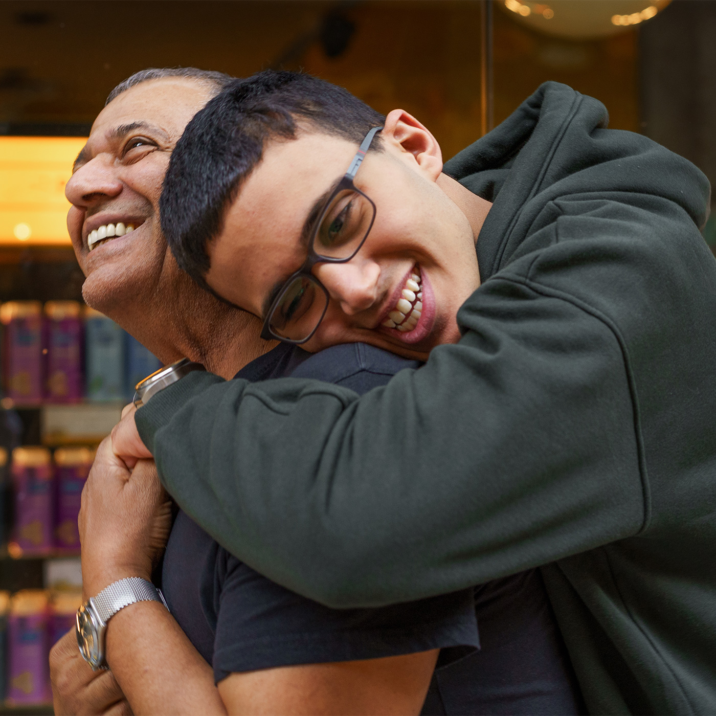 Father and son hugging and smiling