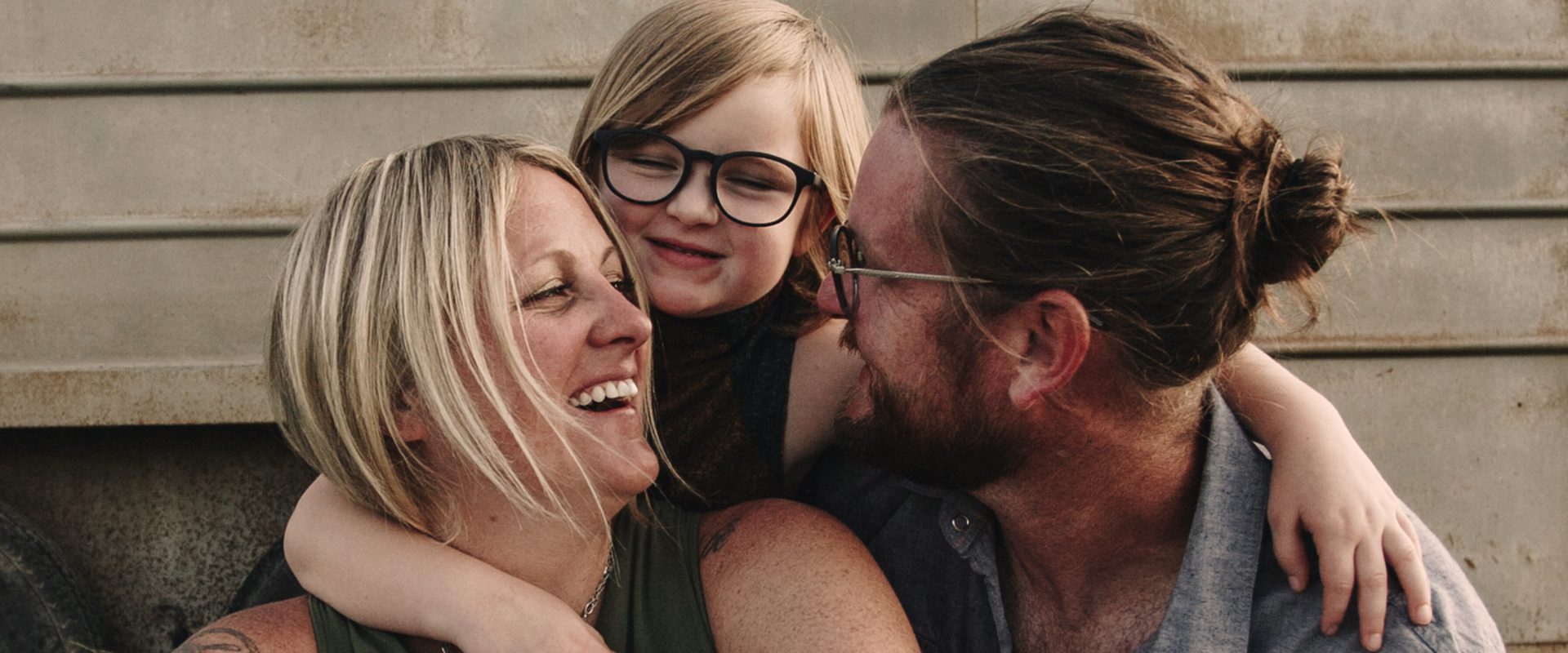 Happy family sharing a joyful moment together outdoors, showing love and warmth.