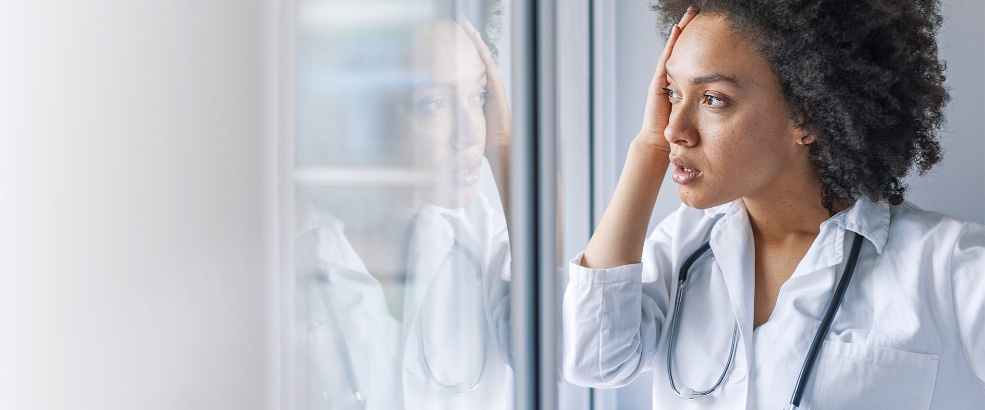 Female doctor looking out a window
