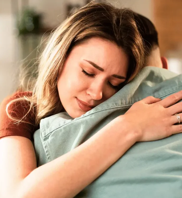 Woman embracing a loved one, symbolizing support and connection during National Suicide Prevention Month.