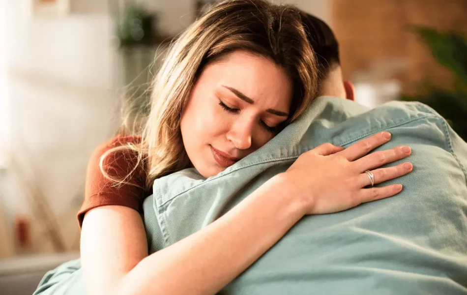 Woman embracing a loved one, symbolizing support and connection during National Suicide Prevention Month.