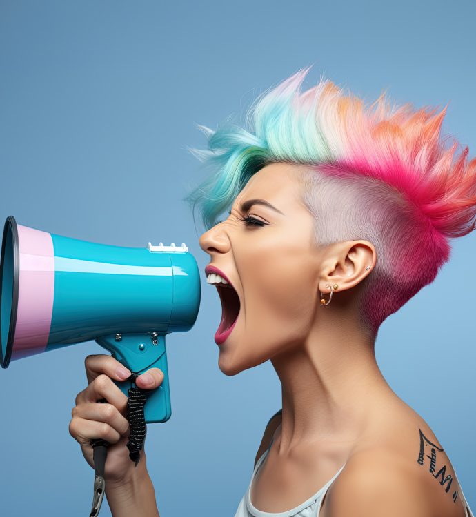 woman with dyed multicolored hair yelling into a bullhorn