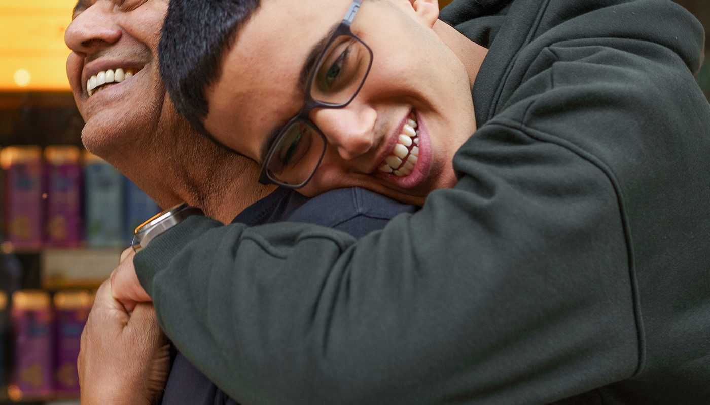 Father and son hugging and smiling