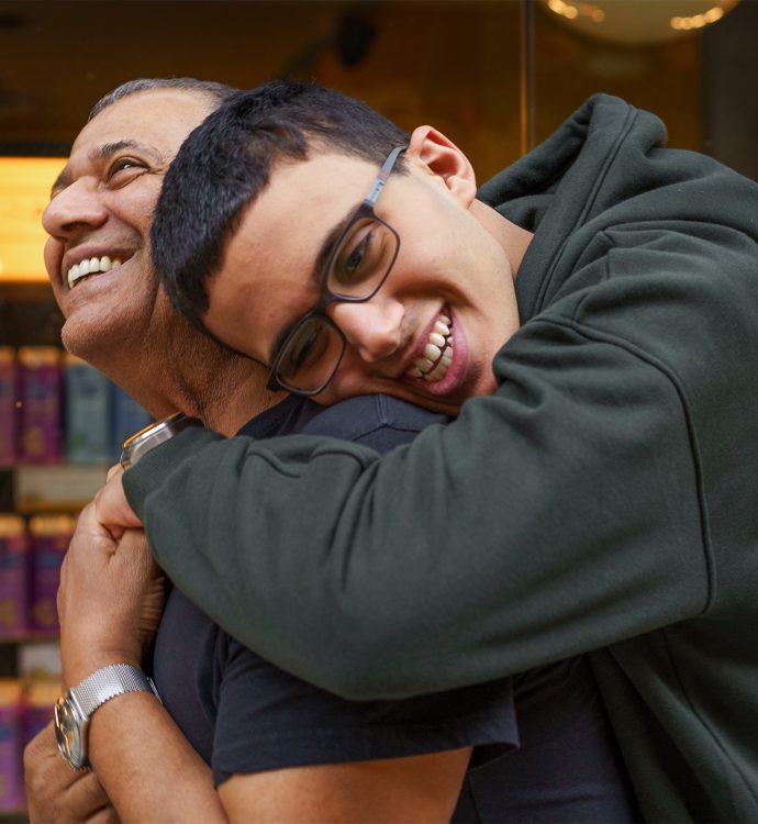 Father and son hugging and smiling