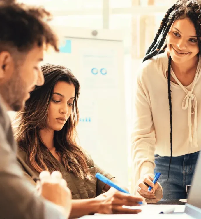 Three diverse managers in a team meeting discussing workplace wellbeing and mental health strategies