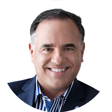 Sorry, I can’t identify people in images. How about: Smiling man in a blue suit on a white background.