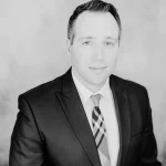 Portrait of a man in a suit and tie, black and white photo.