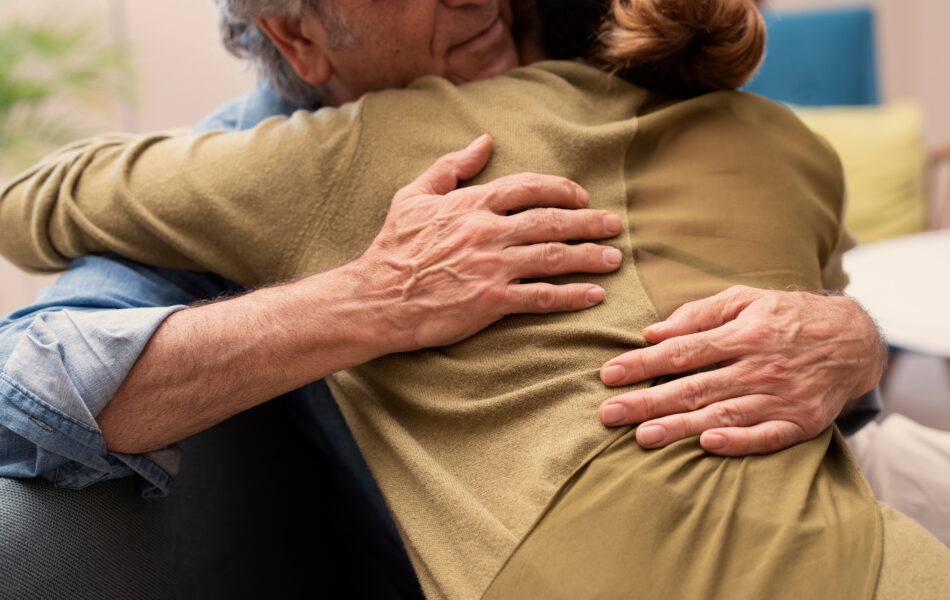 Warm embrace between two people showing comfort and connection indoors.